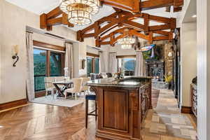 Bar featuring a fireplace, high vaulted ceiling, healthy amount of natural light, and beamed ceiling