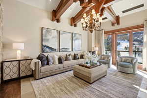 Living area featuring recessed lighting, a chandelier, beamed ceiling, and hardwood / wood-style floors