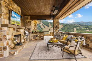 View of patio / terrace with a mountain view, exterior kitchen, and outdoor lounge area