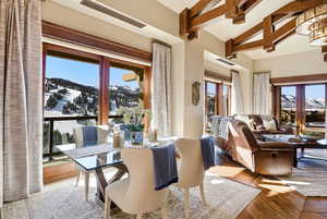 Dining space with a mountain view, healthy amount of natural light, and wood finished floors