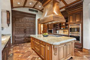 Kitchen featuring island range hood, stainless steel appliances, light stone countertops, recessed lighting, and lofted ceiling