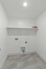 Washroom featuring hookup for a washing machine, electric dryer hookup, tile patterned flooring, and a textured ceiling