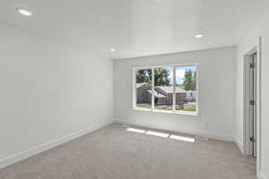 Unfurnished bedroom with carpet floors, a textured ceiling, and recessed lighting