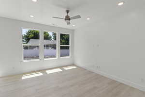 Spare room with light wood finished floors, recessed lighting, and a ceiling fan