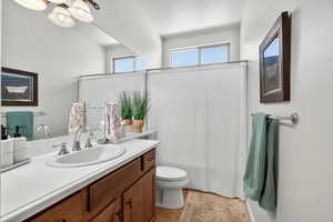 Full bathroom featuring vanity, a shower with shower curtain, and a textured ceiling