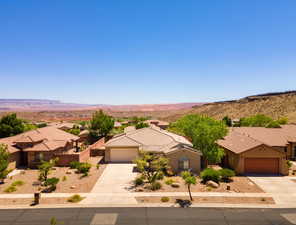 View of front facade featuring concrete driveway, an attached garage, stucco siding, and a mountain view