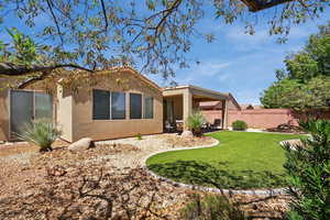 Rear view of house with stucco siding and a patio