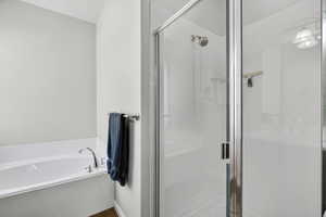 Full bath with a stall shower and a garden tub
