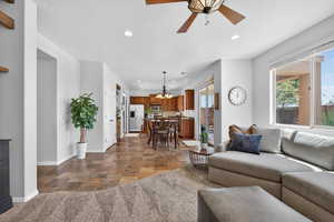 Living room with recessed lighting, healthy amount of natural light, stone finish flooring, and ceiling fan