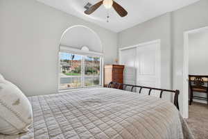 Bedroom featuring a closet, carpet, and a ceiling fan