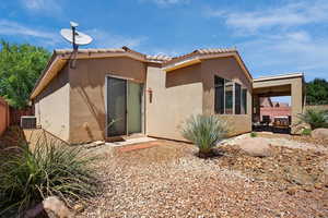 Back of house featuring a ceiling fan, stucco siding, a tile roof, and a patio