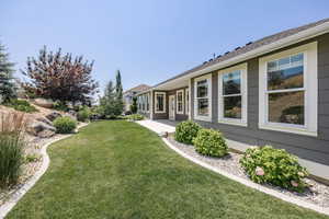 View of grassy yard with a patio area