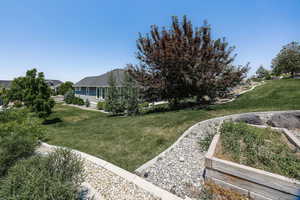 View of green lawn with a garden