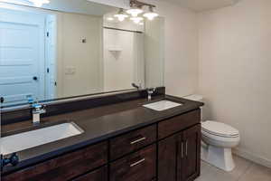 Full bathroom with double vanity and a shower with shower curtain