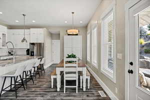 Dining room featuring dark wood-style floors and recessed lighting