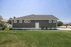 View of front facade with a front lawn and roof with shingles