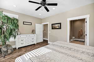 Bedroom featuring recessed lighting, dark wood-type flooring, ceiling fan, and connected bathroom