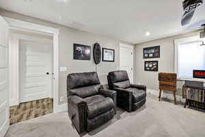 Carpeted home theater featuring baseboards