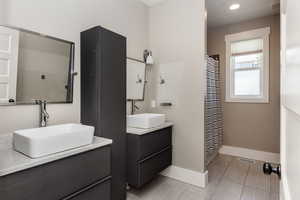 Bathroom with two vanities and recessed lighting