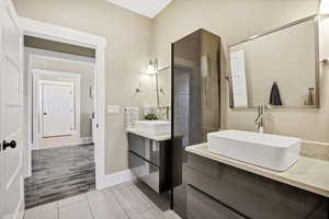 Bathroom with vanity and light wood finished floors