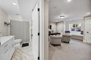 Full bath with vanity, recessed lighting, and curtained shower