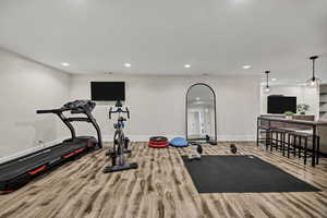 Workout room featuring recessed lighting and wood finished floors