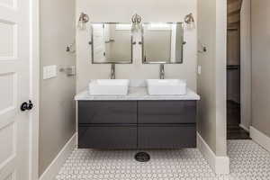 Bathroom featuring double vanity and tile patterned flooring