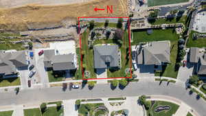 Aerial perspective of suburban area featuring property parcel outlined
