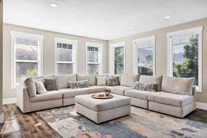 Living area featuring wood finished floors, recessed lighting, and a textured ceiling