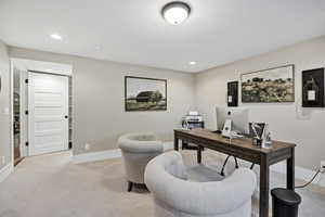 Office space featuring light colored carpet and recessed lighting