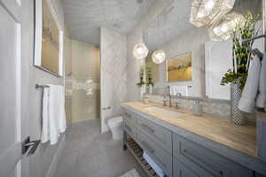 Bathroom featuring vanity, tile patterned flooring, and a walk in shower