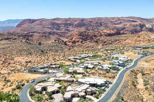 Aerial view of property's location featuring nearby suburban area and mountains