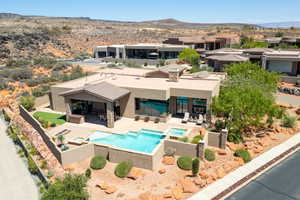 View of pool with an outdoor living space, a mountain view, a patio area, and a pool with connected hot tub