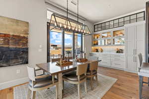 Dining area featuring light wood finished floors and a chandelier