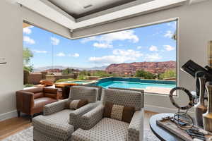 Outdoor pool featuring an in-ground hot tub and a mountain view