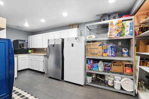 Laundry with white cabinets, recessed lighting, and light countertops
