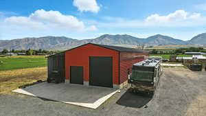 Detached garage featuring a mountain view and a view of rural / pastoral area