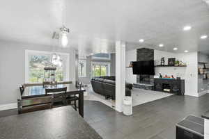 Dining area featuring a textured ceiling and recessed lighting