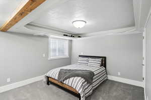 Bedroom with a textured ceiling and carpet flooring