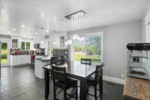 Dining room featuring a textured ceiling and recessed lighting