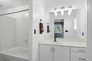 Full bathroom with vanity and shower / tub combination