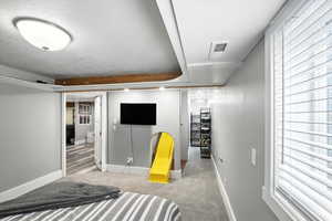 Bedroom with carpet flooring and a textured ceiling