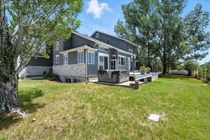 Back of property with stucco siding and stone siding