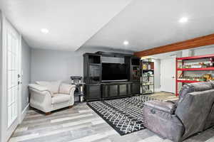 Living room with wood finished floors and recessed lighting