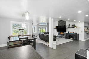 Dining space featuring a large fireplace and a textured ceiling