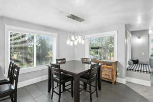 Dining area with plenty of natural light and a textured ceiling