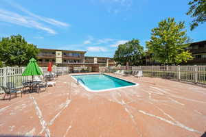 Community pool featuring a patio