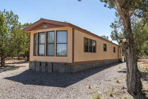 View of side of property with crawl space