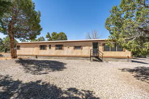 View of front of home featuring metal roof and crawl space