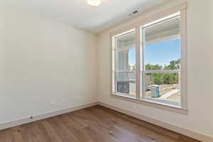 Spare room featuring wood finished floors and baseboards